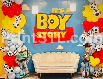 Toy Story themed baby shower backdrop with balloons, Buzz, Woody, and sofa.