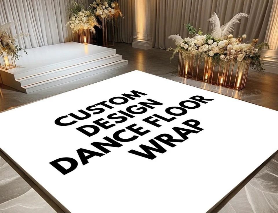 White dance floor wrap with custom design text in a decorated venue.