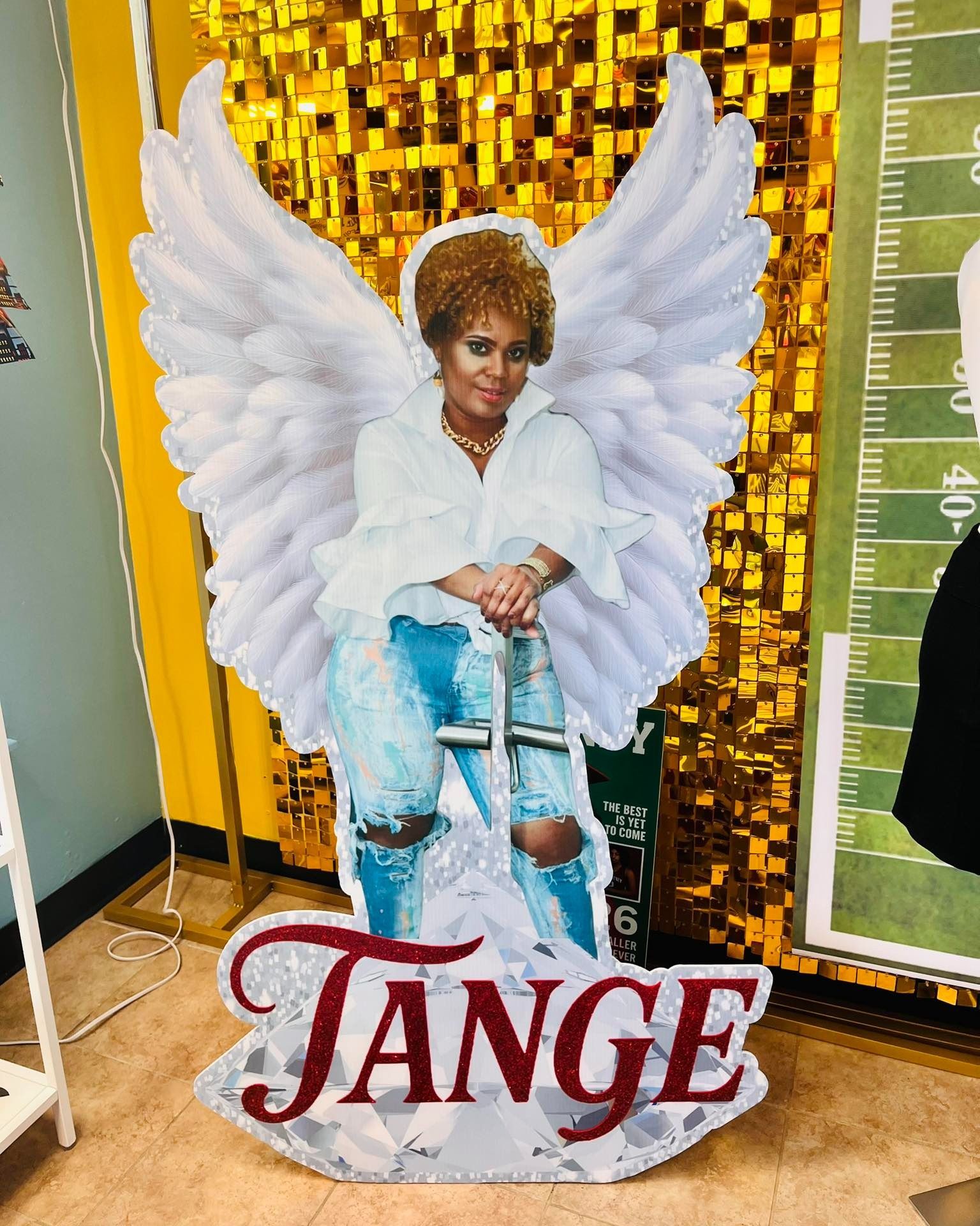 Cutout of a person with angel wings, holding crutches, the name 