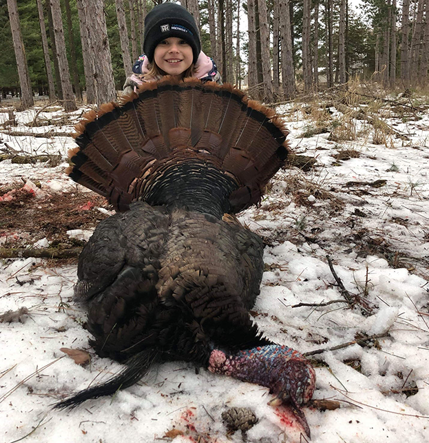 Smiling girl holding a turkey