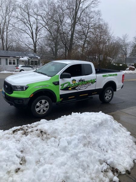 Ford Ranger pickup truck with green and white decals parked near snow.