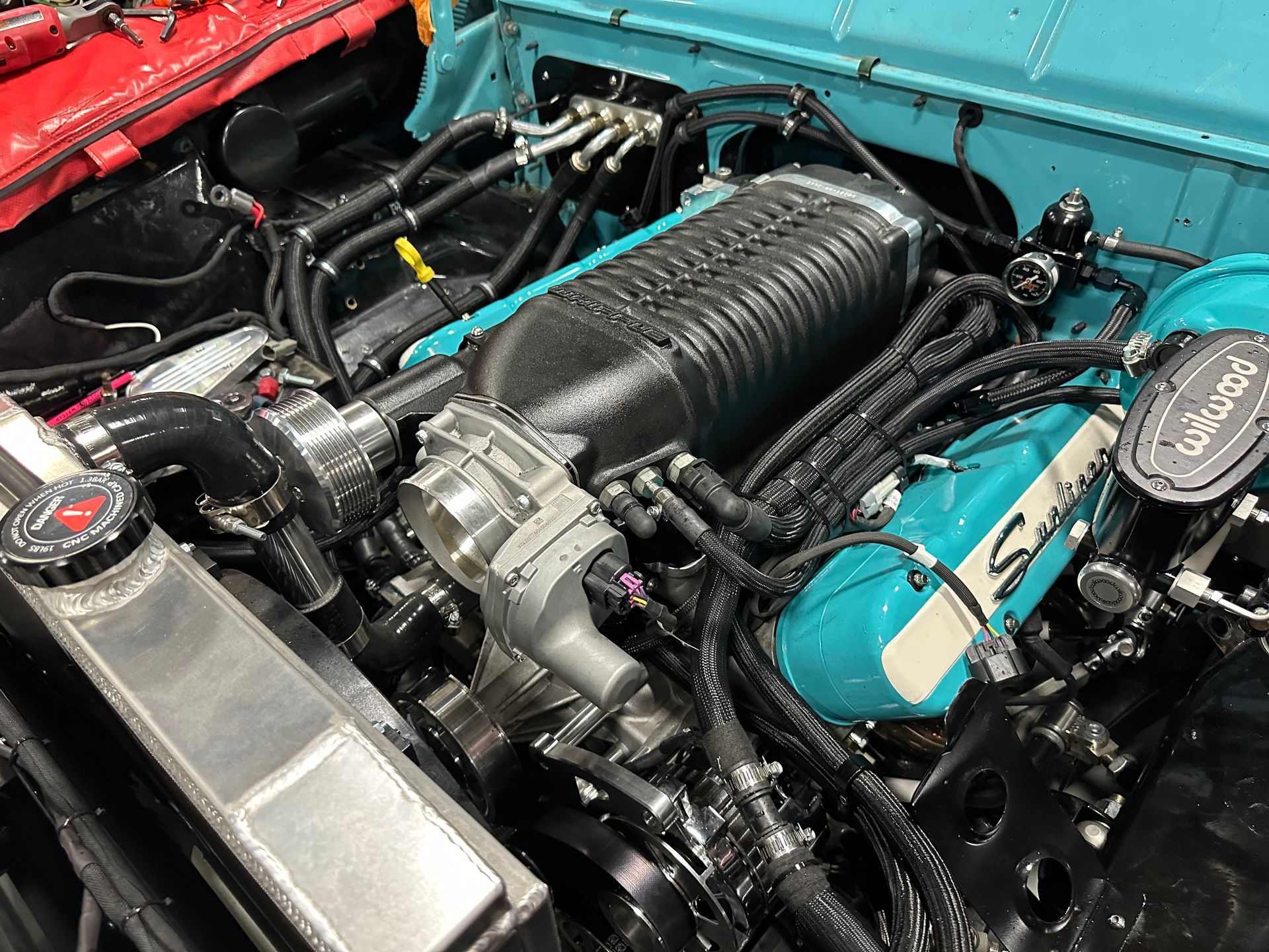 A close up of a blue and black engine in a car.