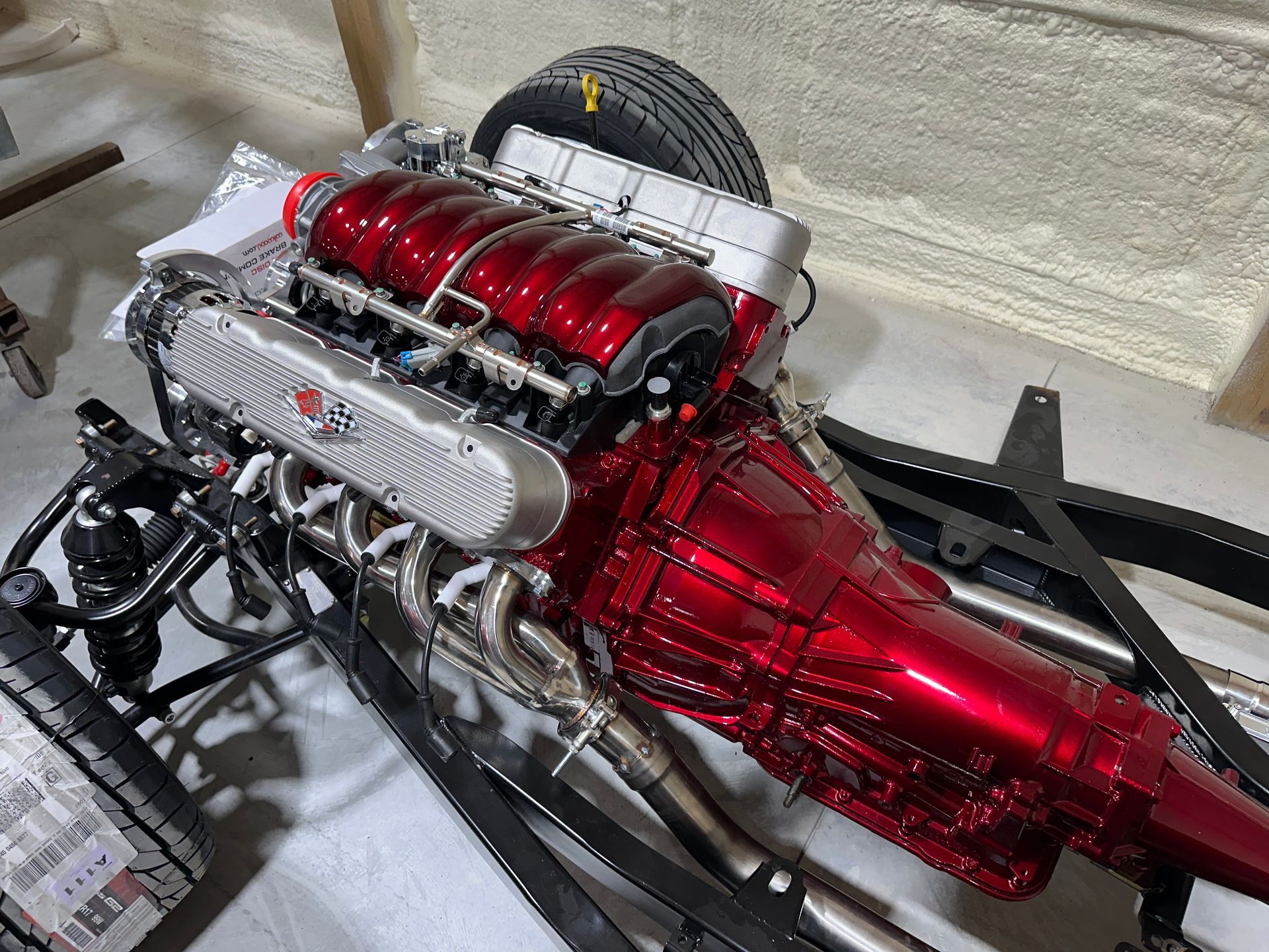 A red engine is sitting on top of a white table.