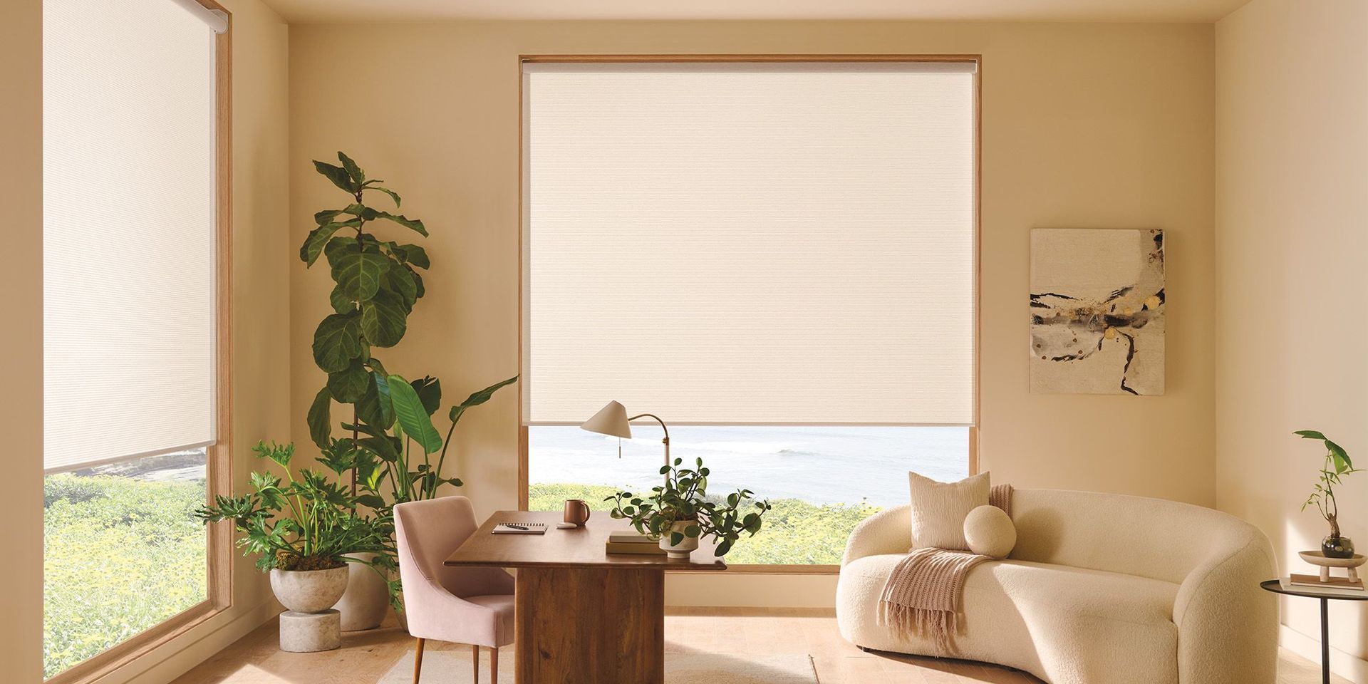 Bright living room with beige sofa, potted plants, and large windows with blinds