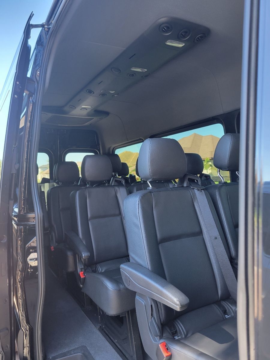 the inside of a van with a lot of seats and a ceiling light .