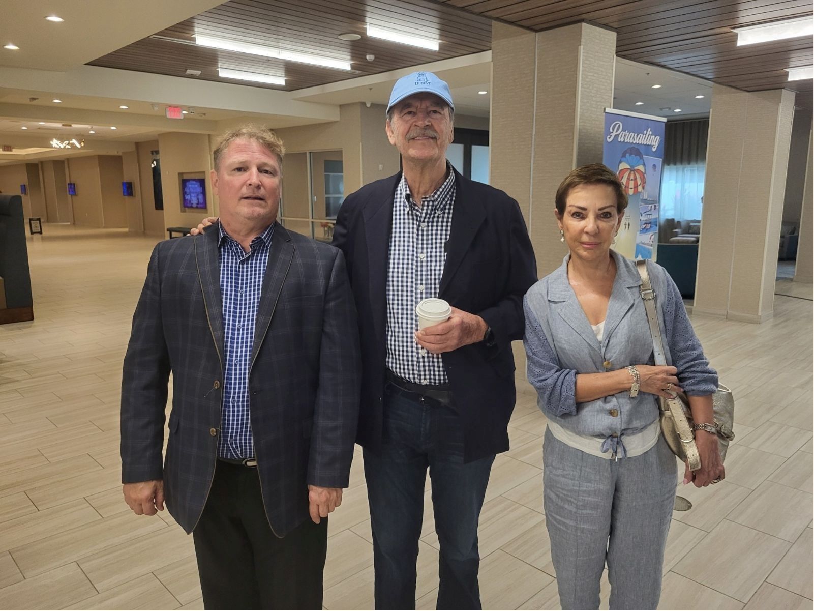 Shampoozie standing in a hallway with two other people.