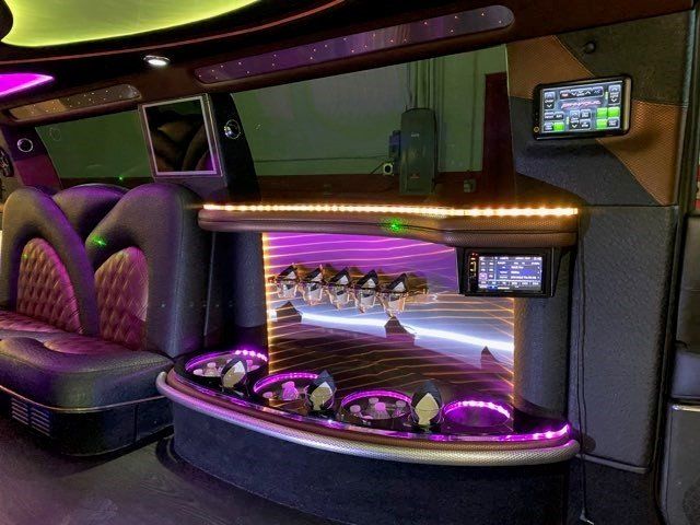 The inside of a limousine with purple lights