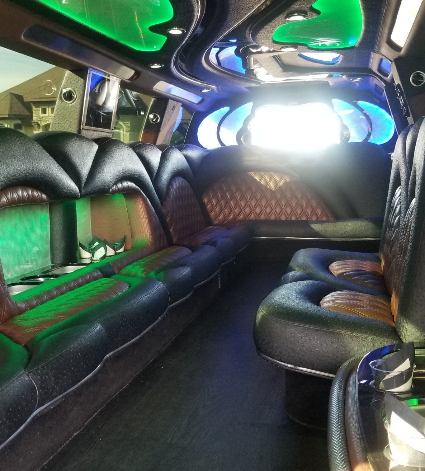 The inside of a limousine with green lights