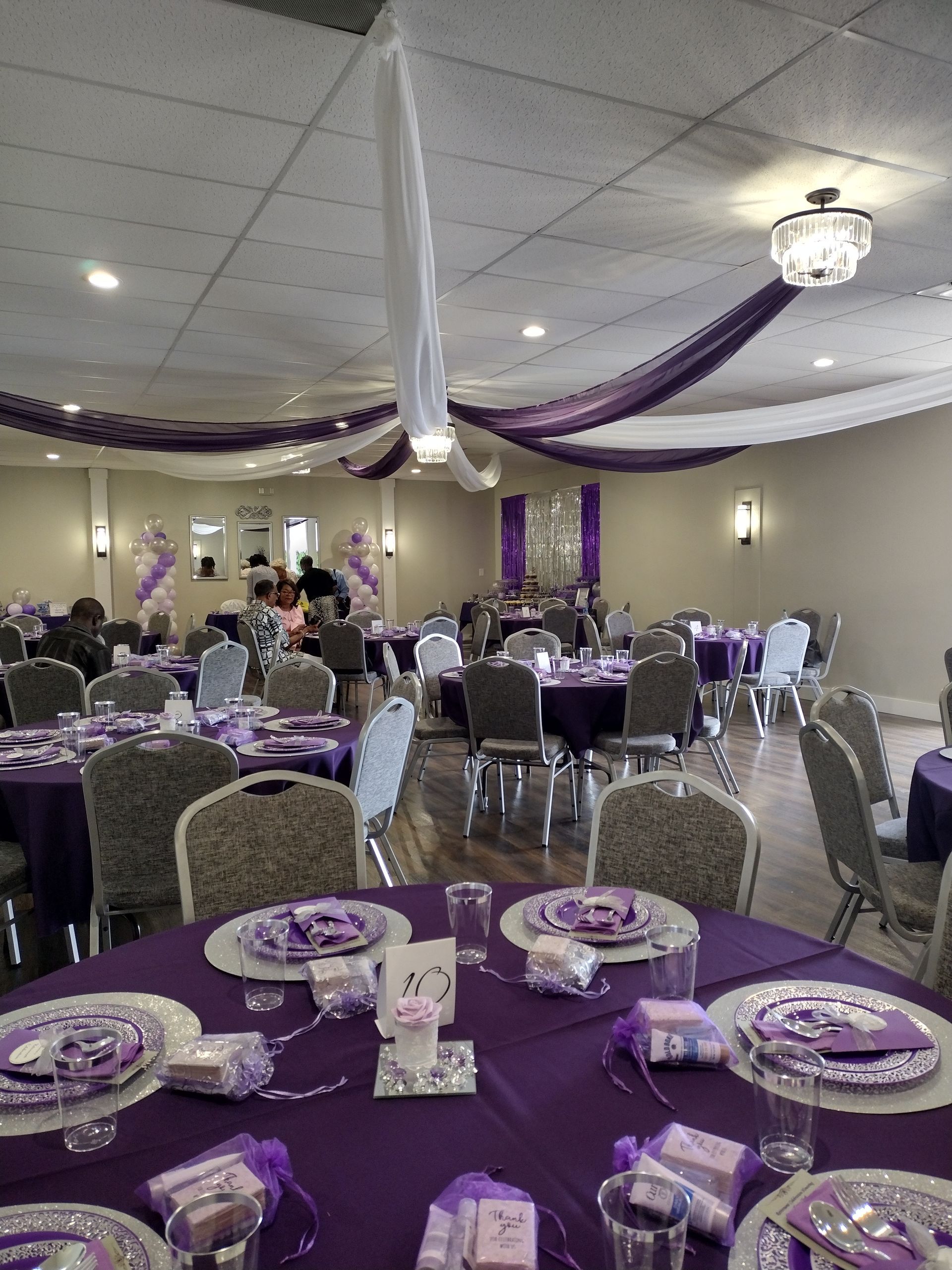 A large room with purple tables and chairs