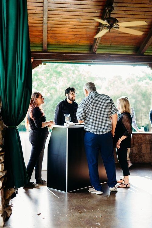 A group of people are standing around a table in a room.