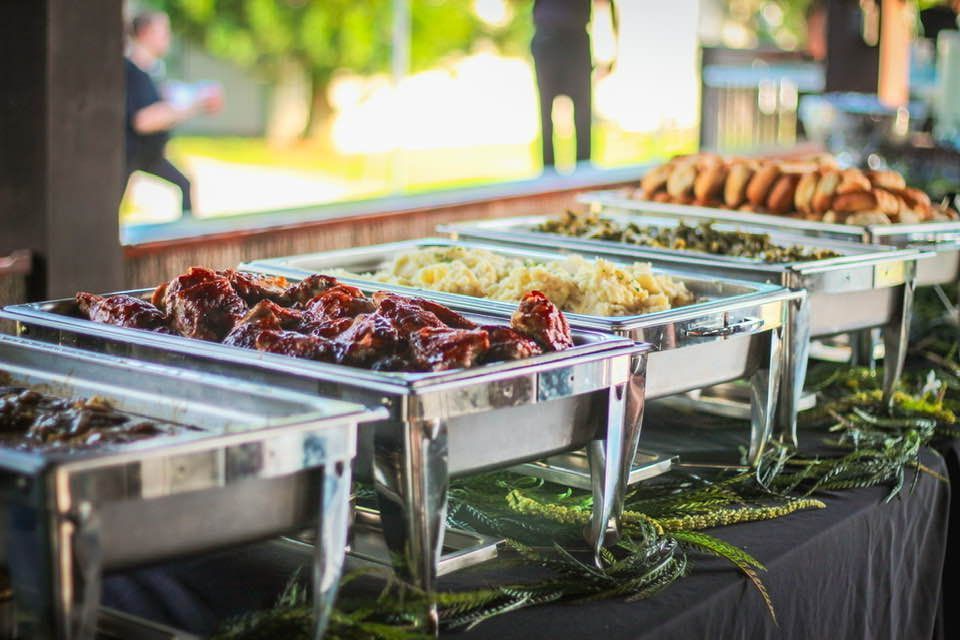 A buffet table with a variety of food on it.