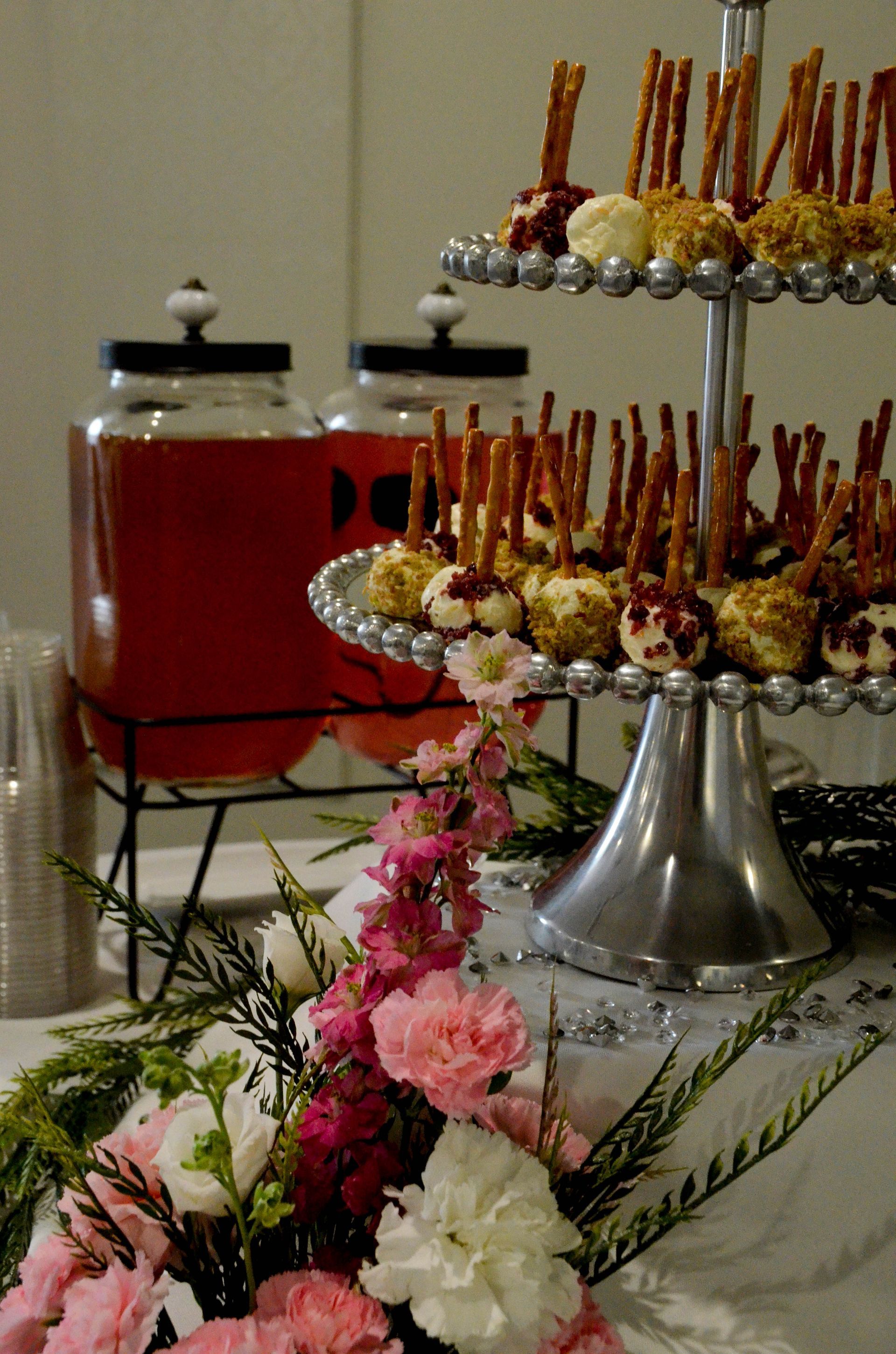 A table with a display of food and flowers on it