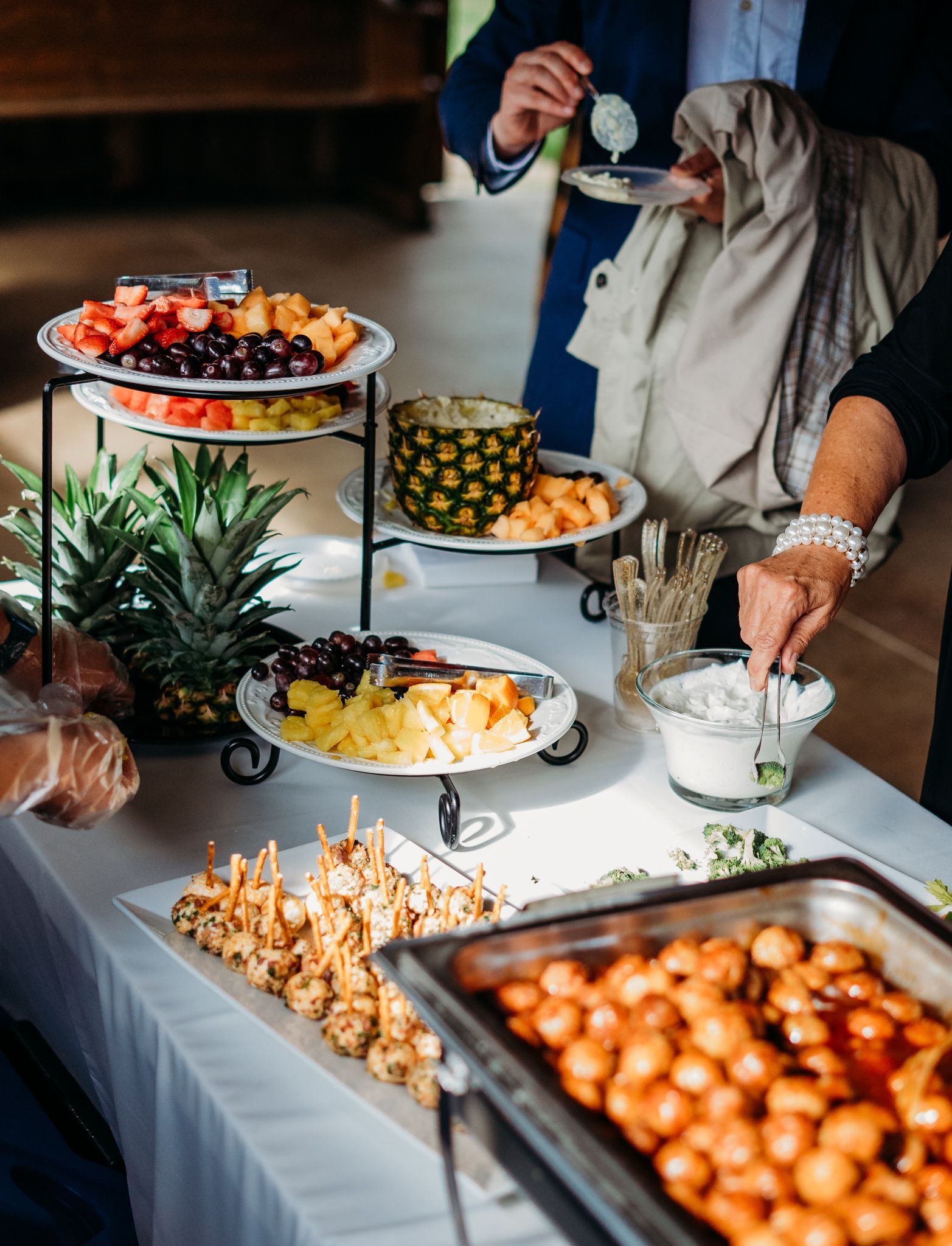 A buffet table with a variety of fruits and vegetables on it.