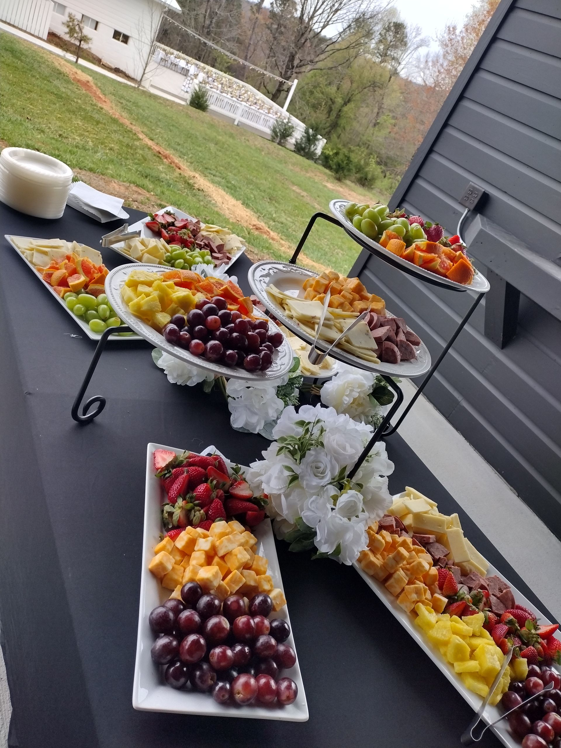 A table topped with plates of fruit and vegetables.