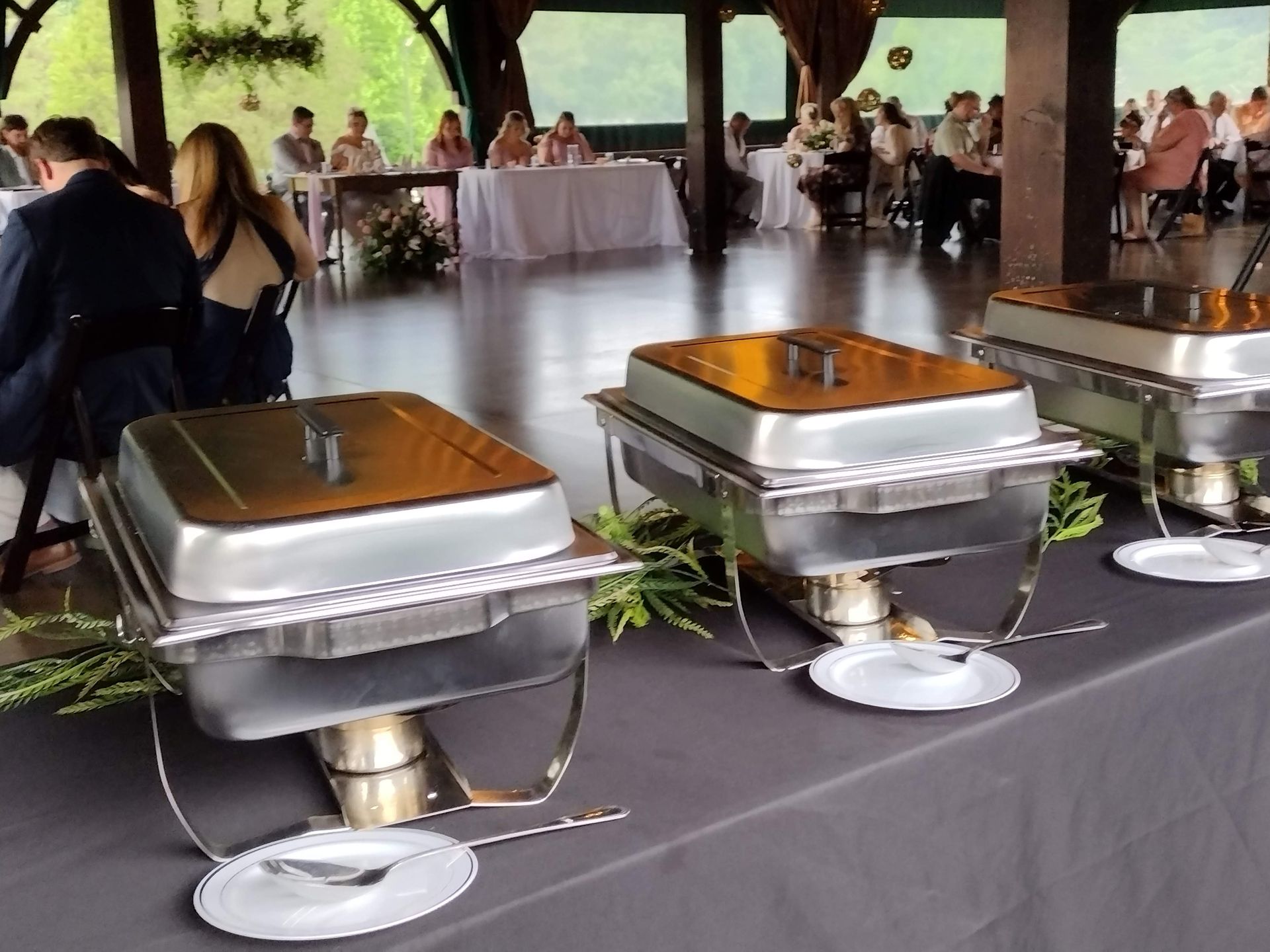 A buffet table with plates and utensils on it