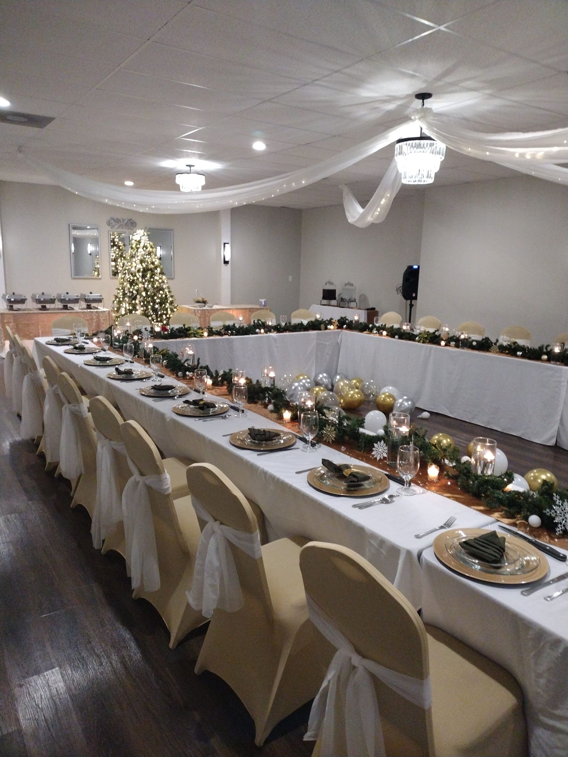 A long table with plates and candles on it in a room.