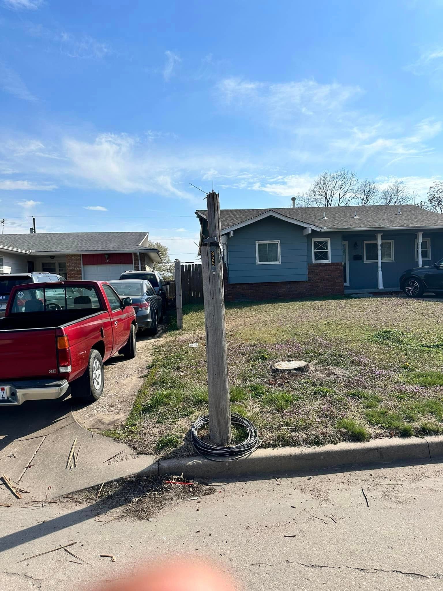 A red truck is parked in front of a house.