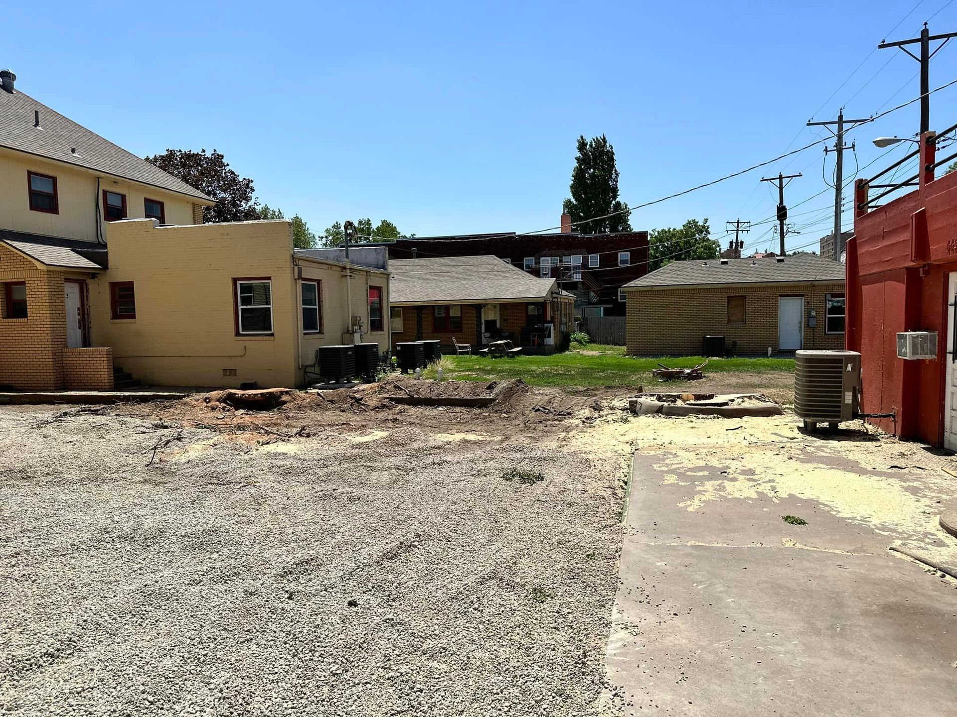 A gravel driveway leads to a row of houses