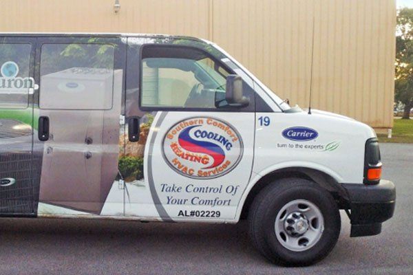 White van with HVAC branding, including a Carrier logo.