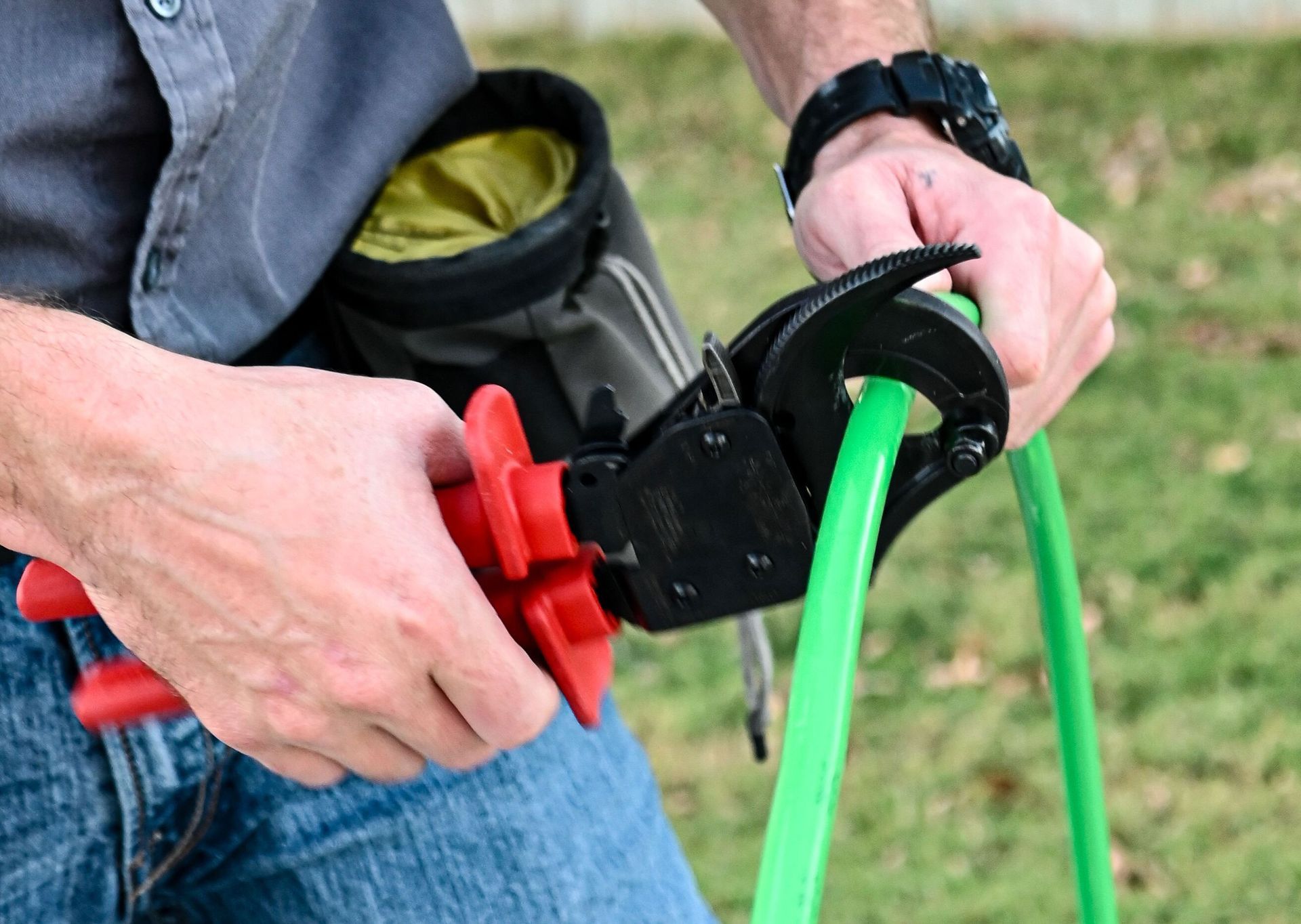 Two men shaking hands outside a building, watched by two others.