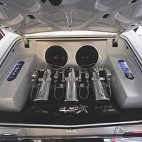 The trunk of a car with a lot of speakers in it.