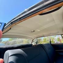 A person is looking up at the ceiling of a car.