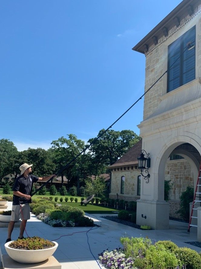 a man is cleaning the windows of a large building