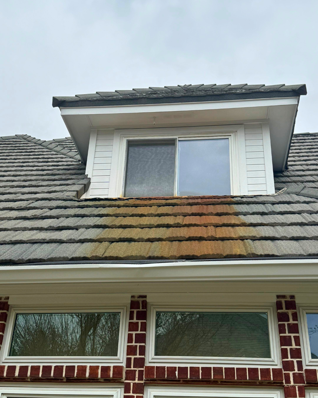 A house with a roof that has a window on it