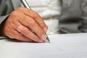 Elderly signing legal document