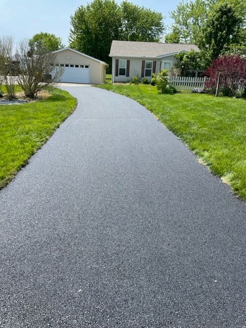 A driveway leading to a house with a garage