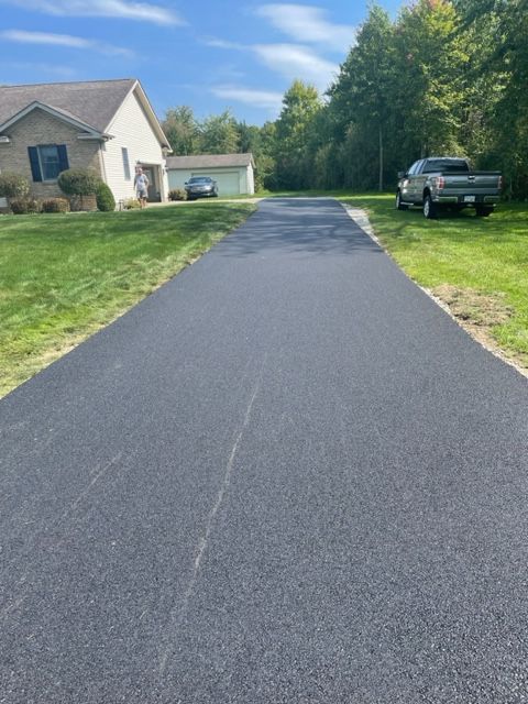 A truck is parked on the side of the road in front of a house
