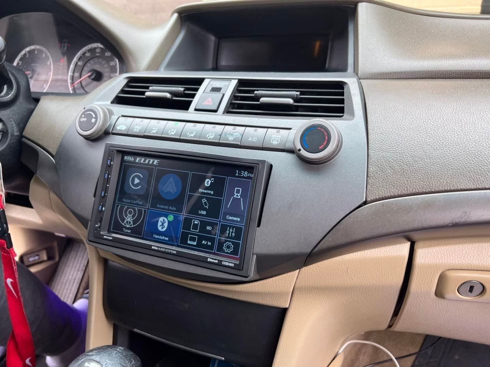 Car dashboard with a large touchscreen infotainment system and air vents above it