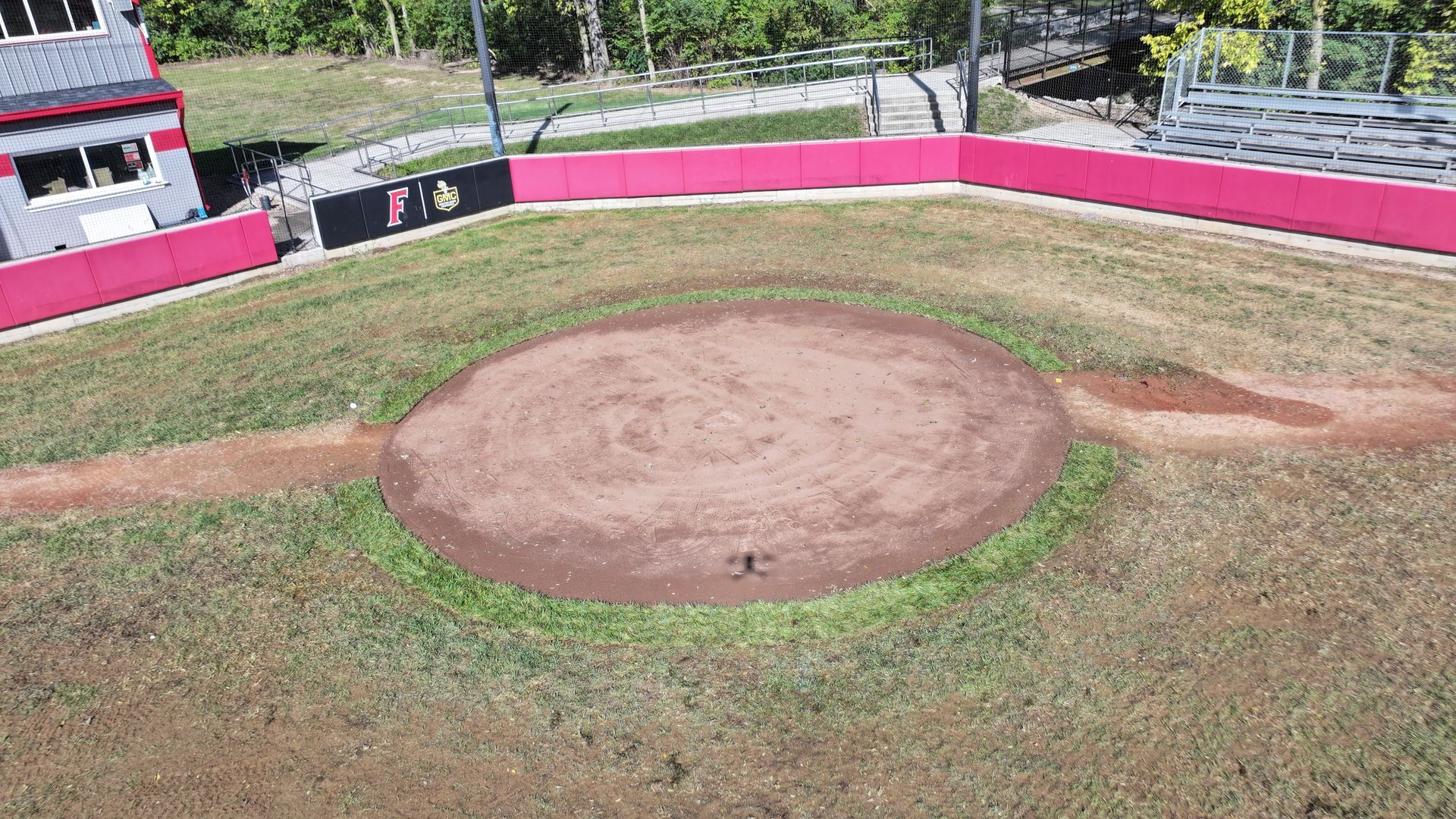 Baseball field with a dirt pitcher’s mound and pink-and-white outfield wall