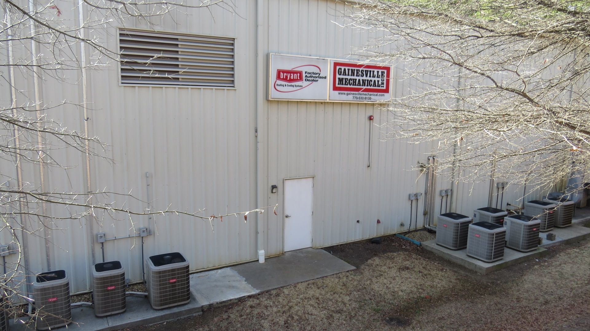 Two Bryant HVAC units shown side by side, a gray furnace cabinet and outdoor condenser.