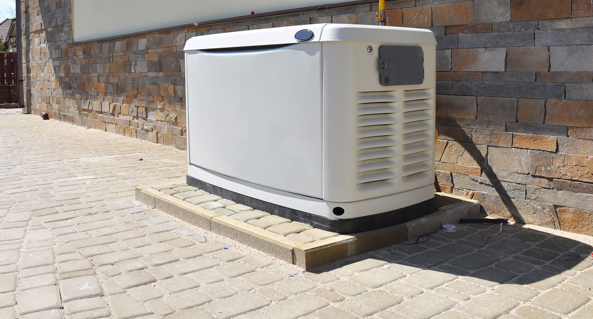 White wall-mounted water heater with a blue digital display reading 120°F.