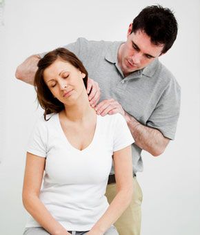 Physical therapist massaging a woman's neck