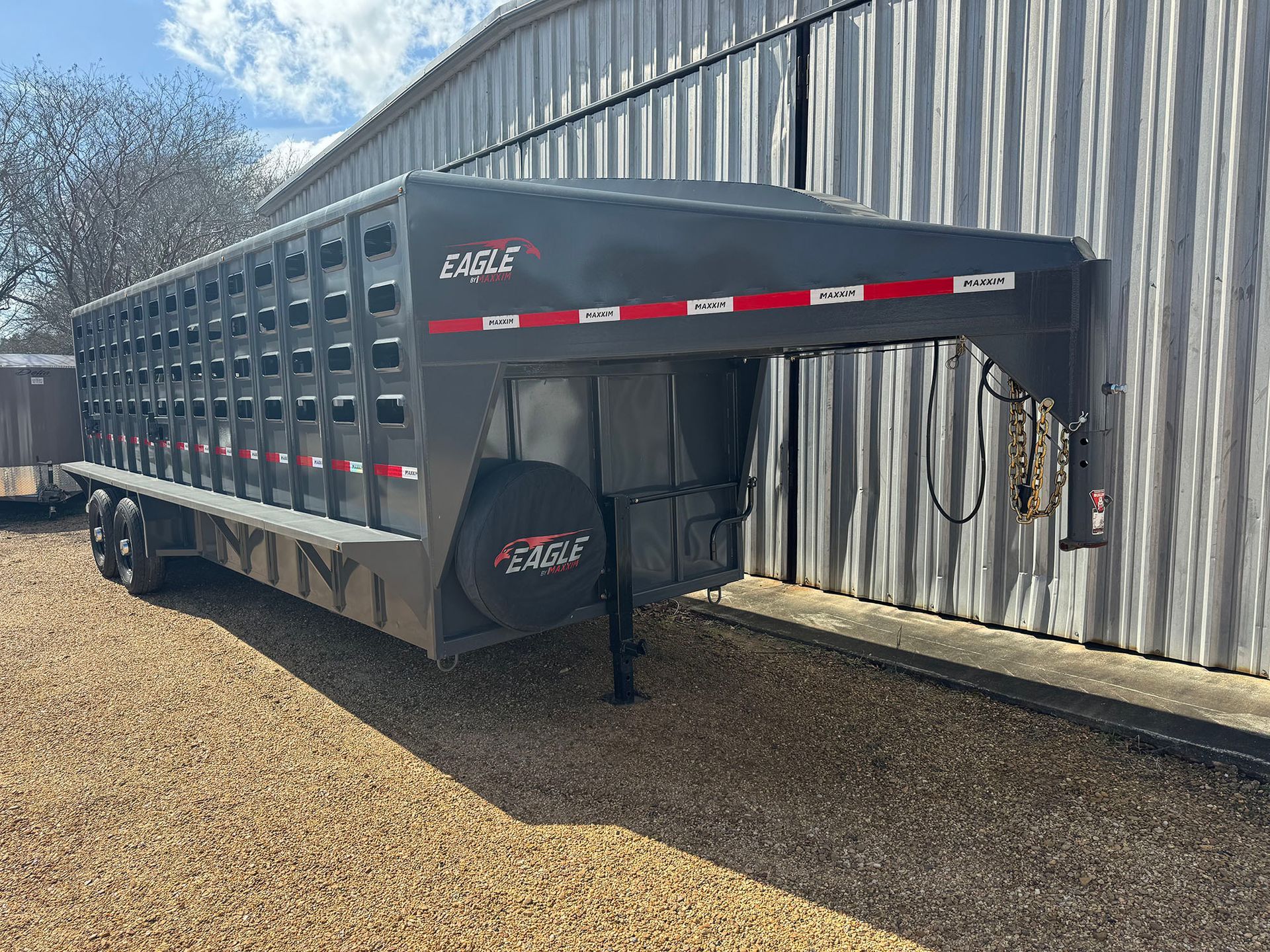 A horse trailer is parked in front of a building.