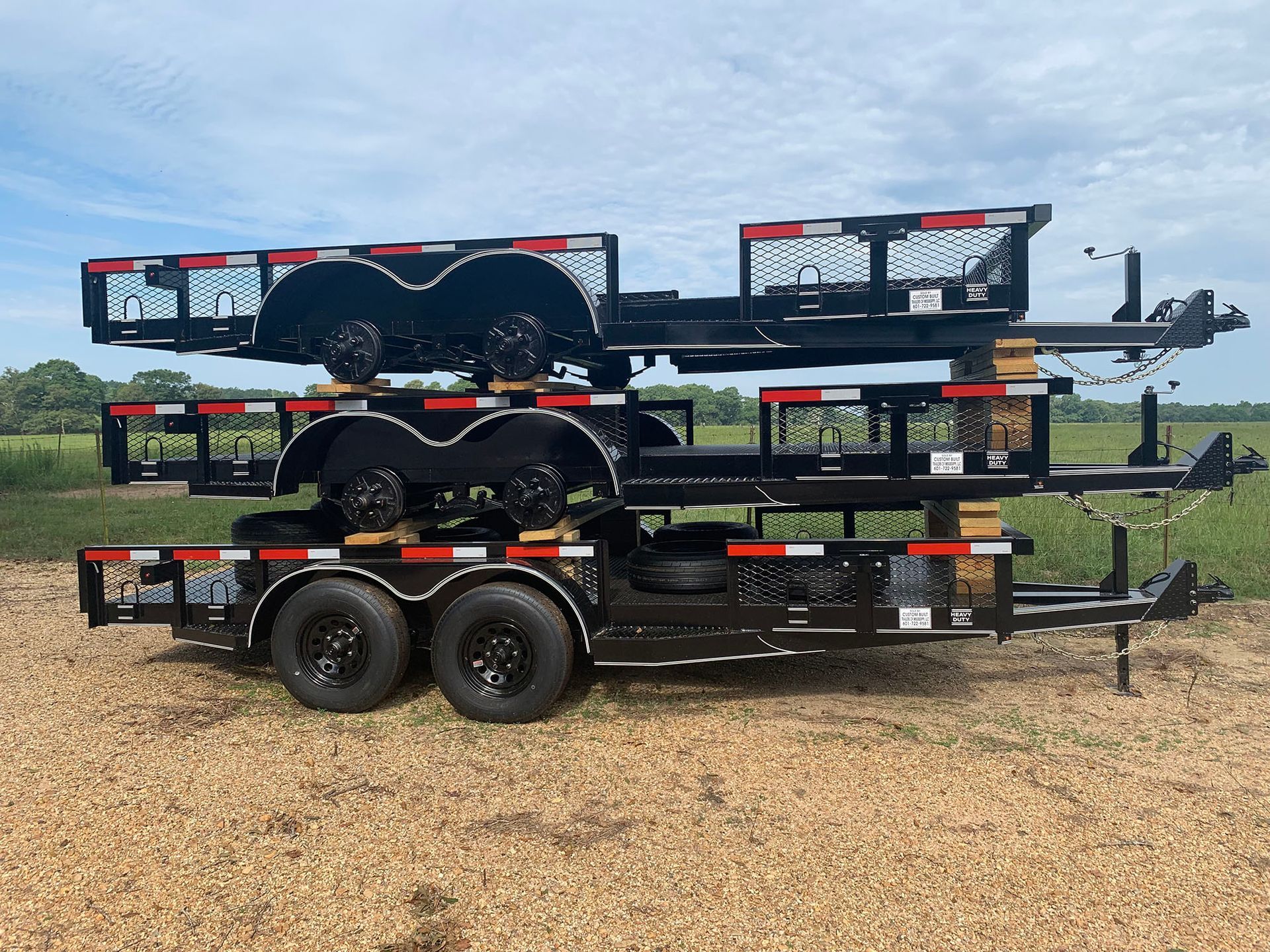 A trailer is stacked on top of each other in a field.