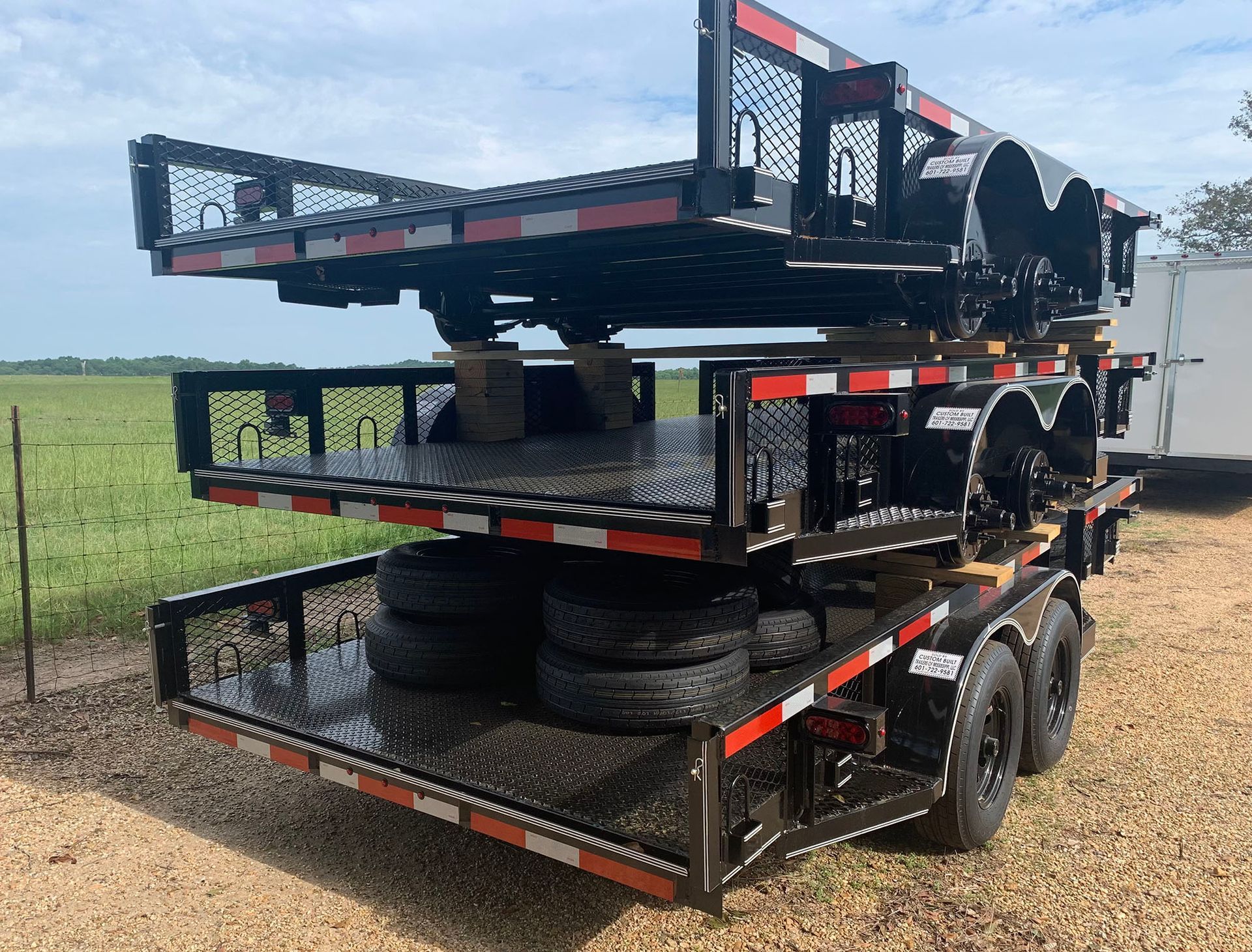 A trailer with a stack of tires on top of it.