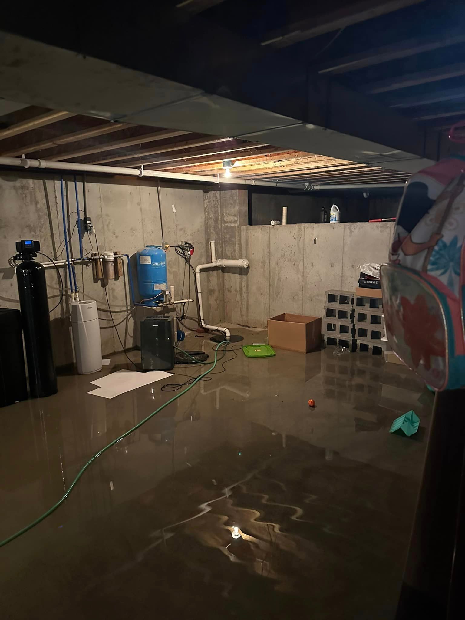 A flooded basement with a lot of water on the floor.