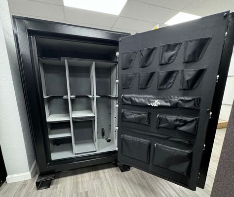Open black gun safe with gray interior and door storage pockets.