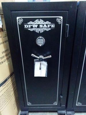 Black DFW SAFE safe with combination lock and handle, in a store setting.