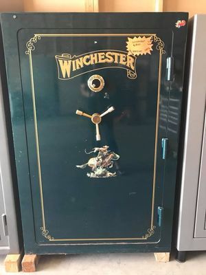 Green Winchester safe with gold trim and cowboy graphic.