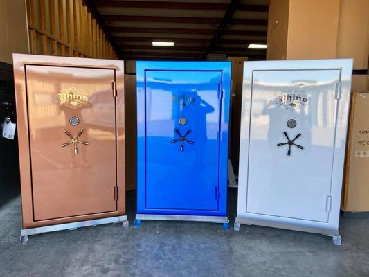 Three colorful gun safes: copper, blue, and white, with combination locks.