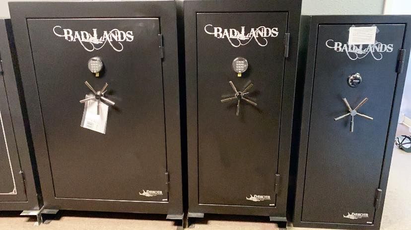 Three black Badlands gun safes displayed at a store.