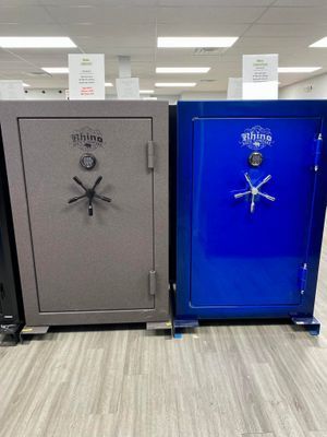 Two Rhino gun safes, one gray and one blue, displayed on a store floor.