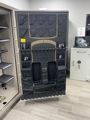 Open gun safe interior with dark gray storage features, beige trim, and a Browning logo.