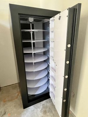 Black safe with open white door revealing circular shelves.