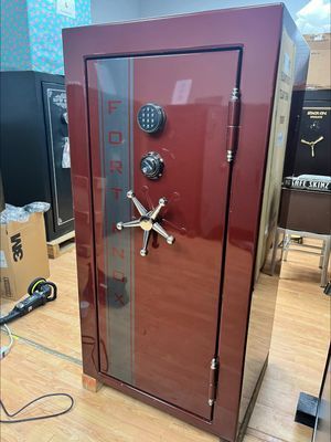 Red Fort Knox safe with digital keypad, combination dial, and star-shaped handle.