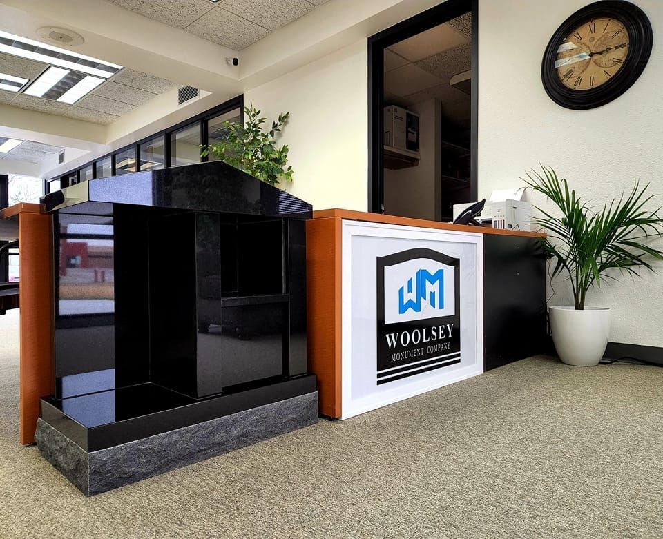 A clock hangs on the wall above a woolsey sign